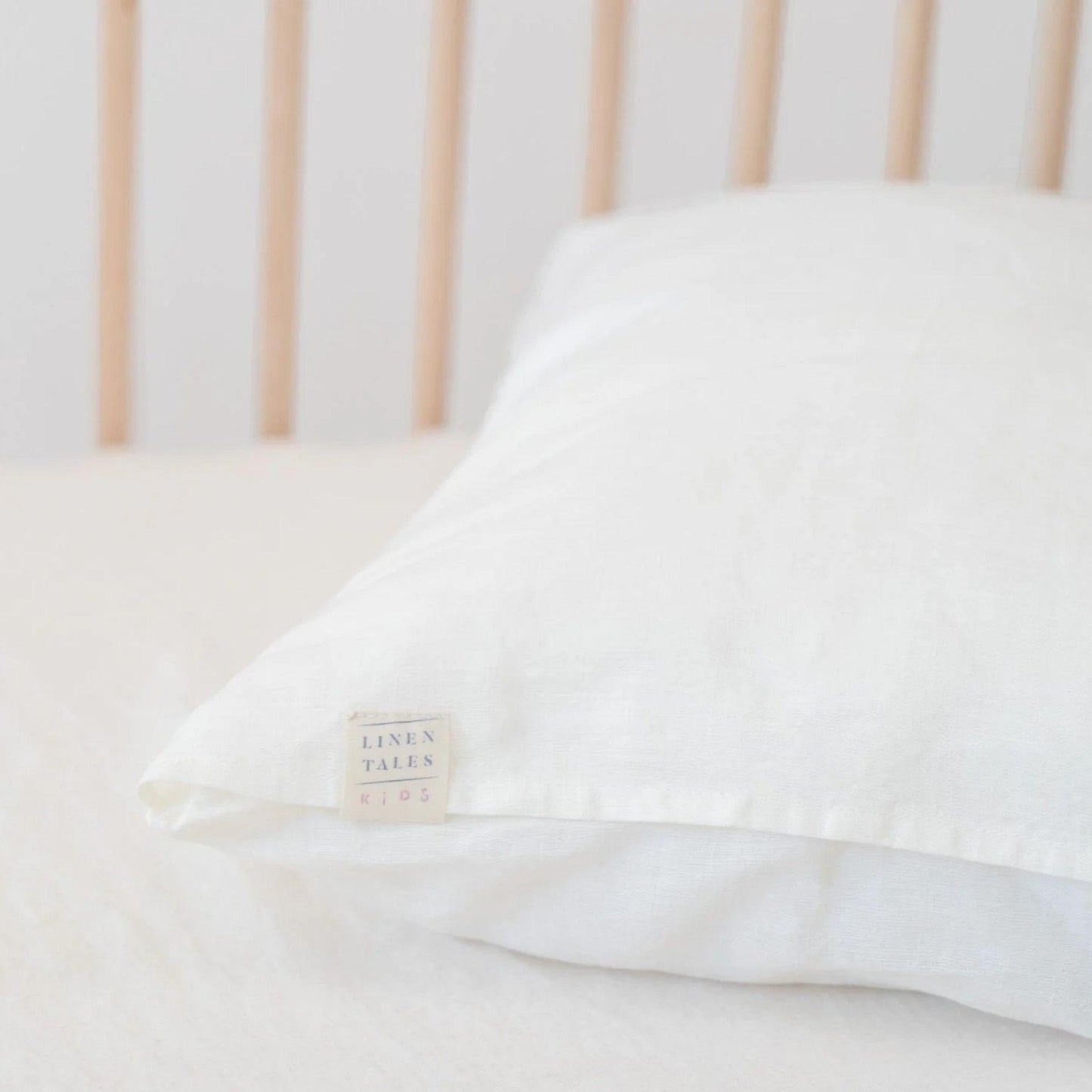 White pillow with a visible brand label on a neutral background