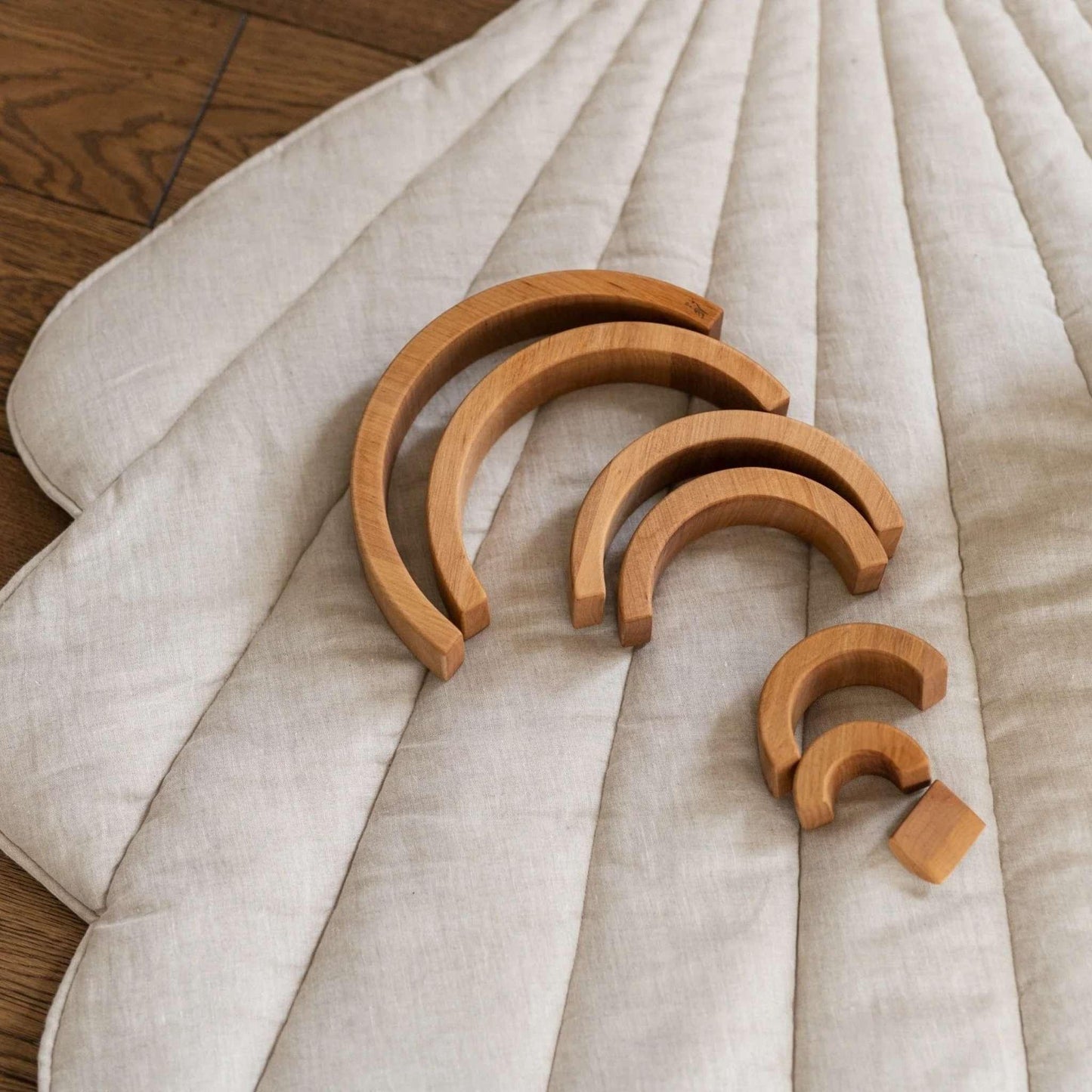 Set of wooden arcs on a textured fabric surface