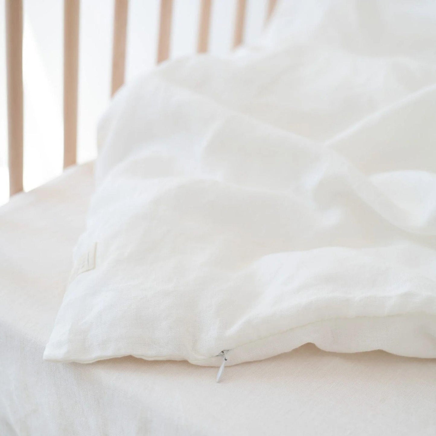 Close-up of a white pillow on a bed with a blurred background