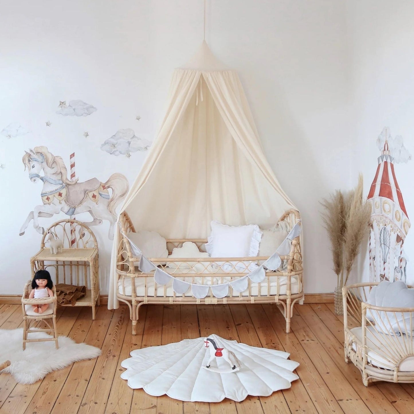 Children's room with a crib, rocking horse, and toys on a wooden floor.