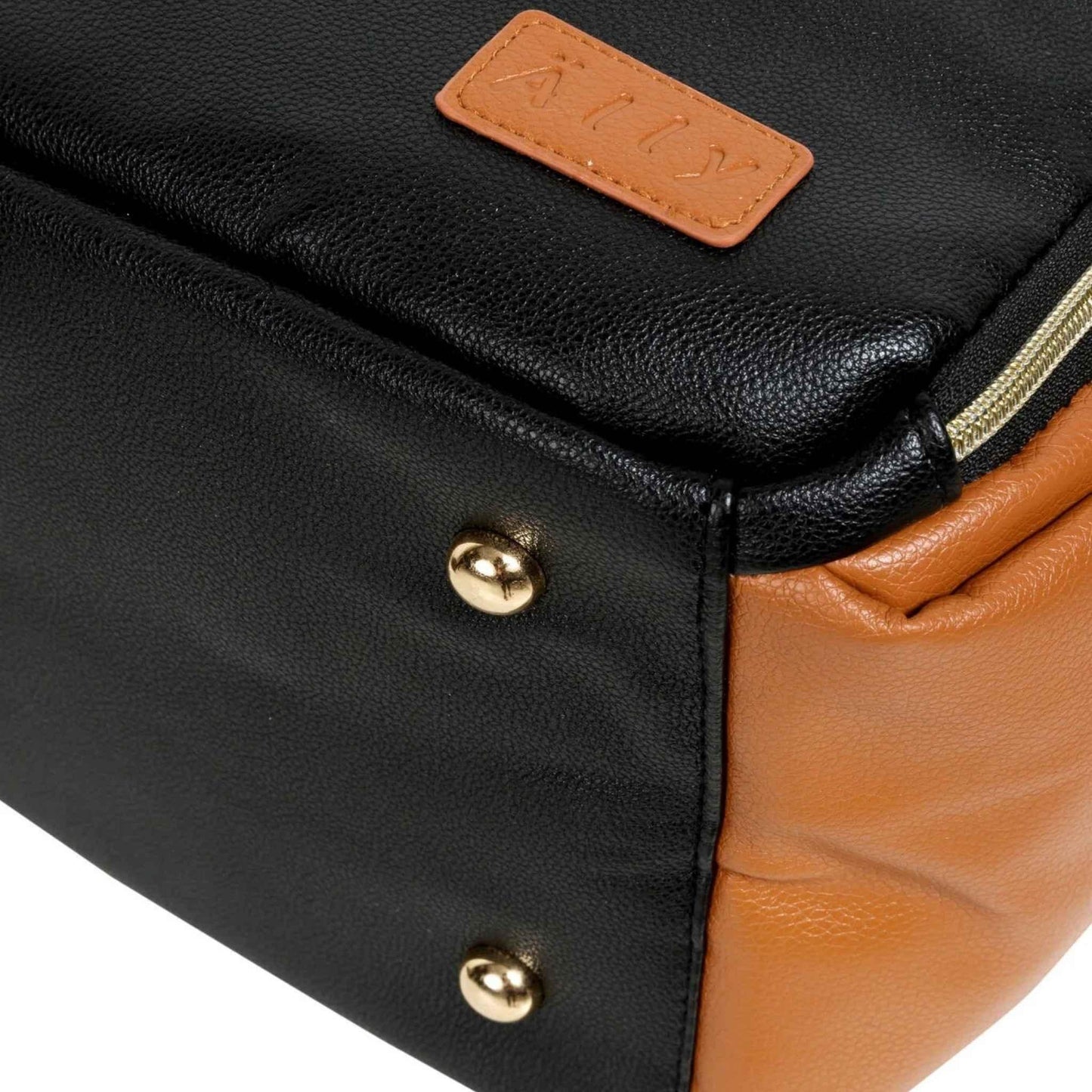 Close-up of a black and brown leather bag with gold buttons and a visible brand label.