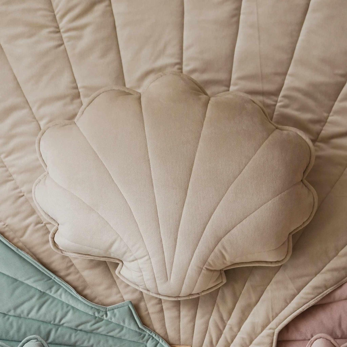 Close-up of a beige quilted fabric with a scalloped edge