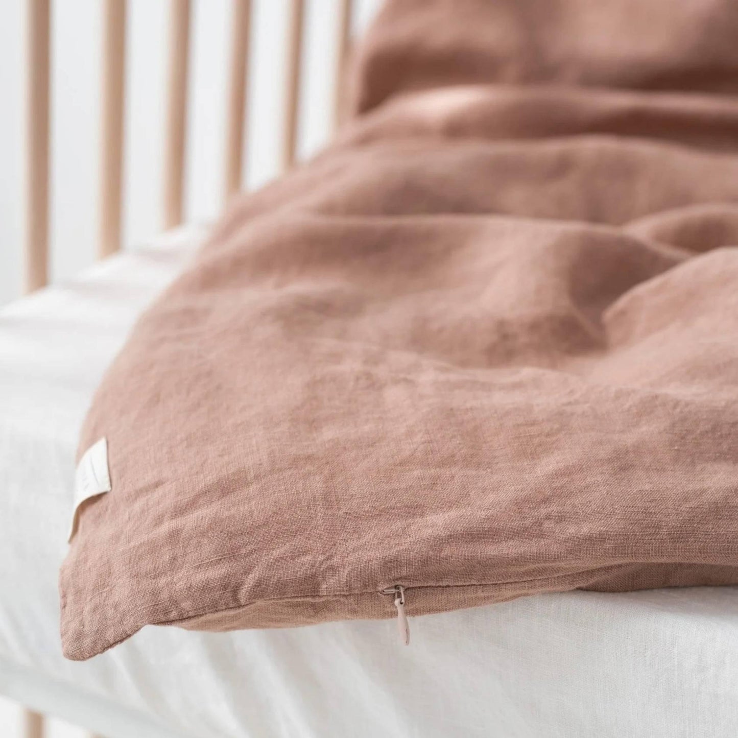 Brown textured pillow on a white bed