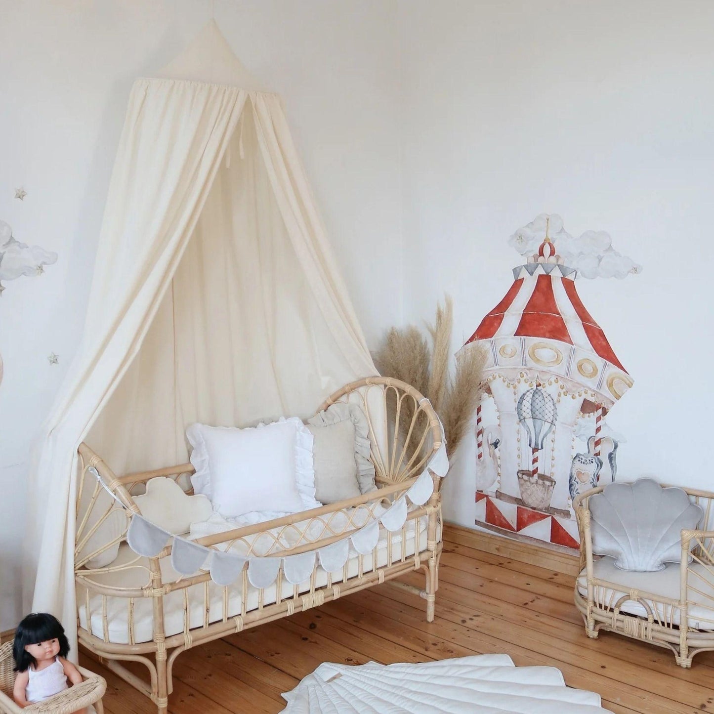 Children's room with a crib, play tent, and toys on a wooden floor.