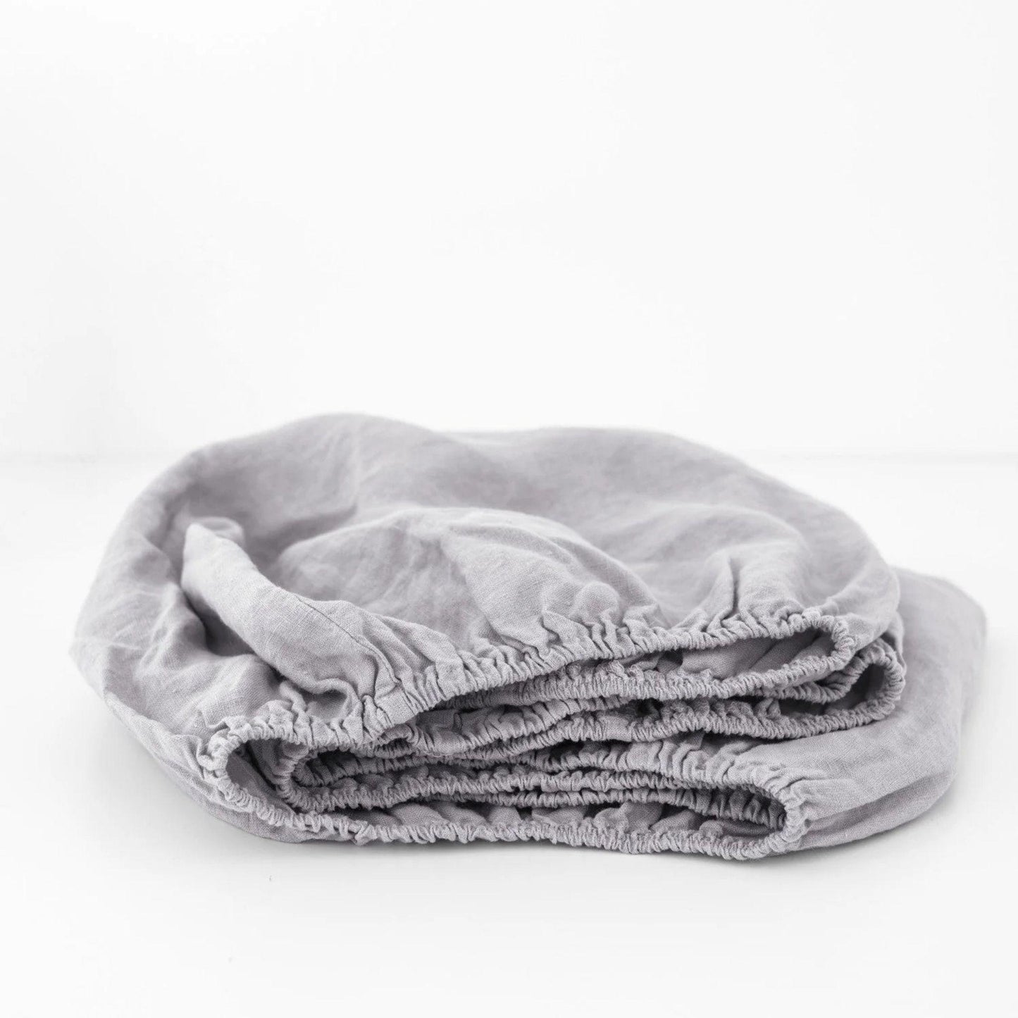Folded gray blanket on a white background