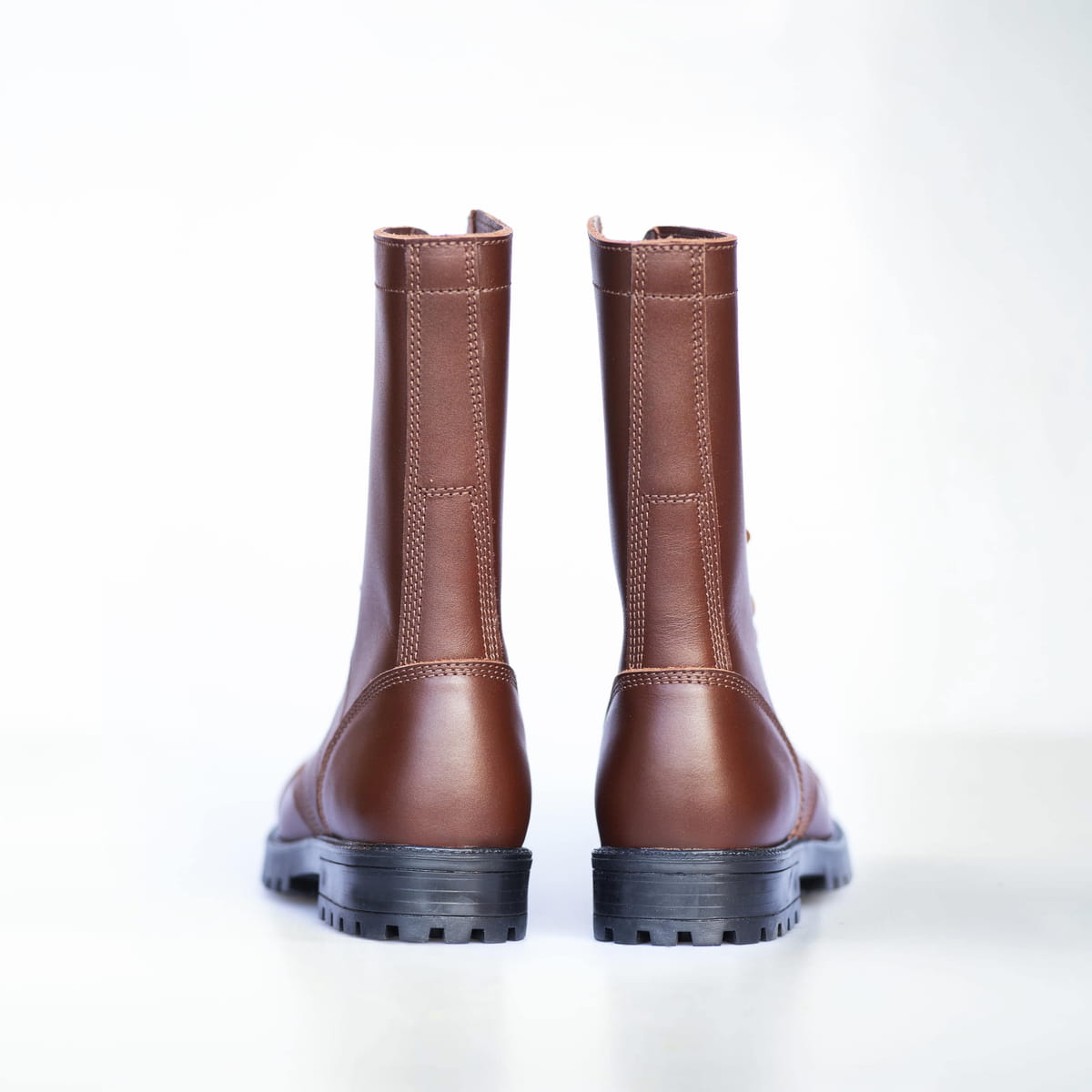 Pair of brown leather boots on a white background
