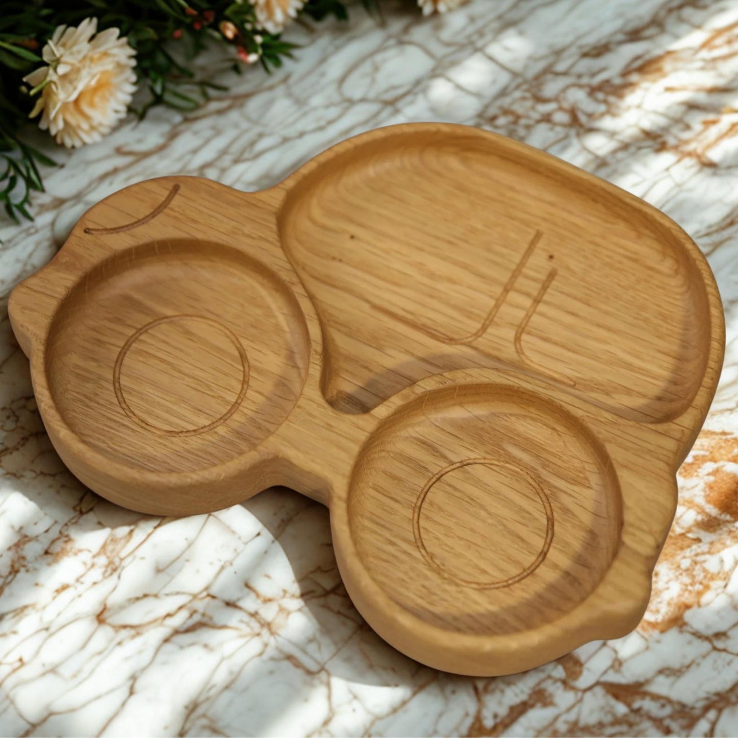 Wooden tray with a unique design on a marble surface