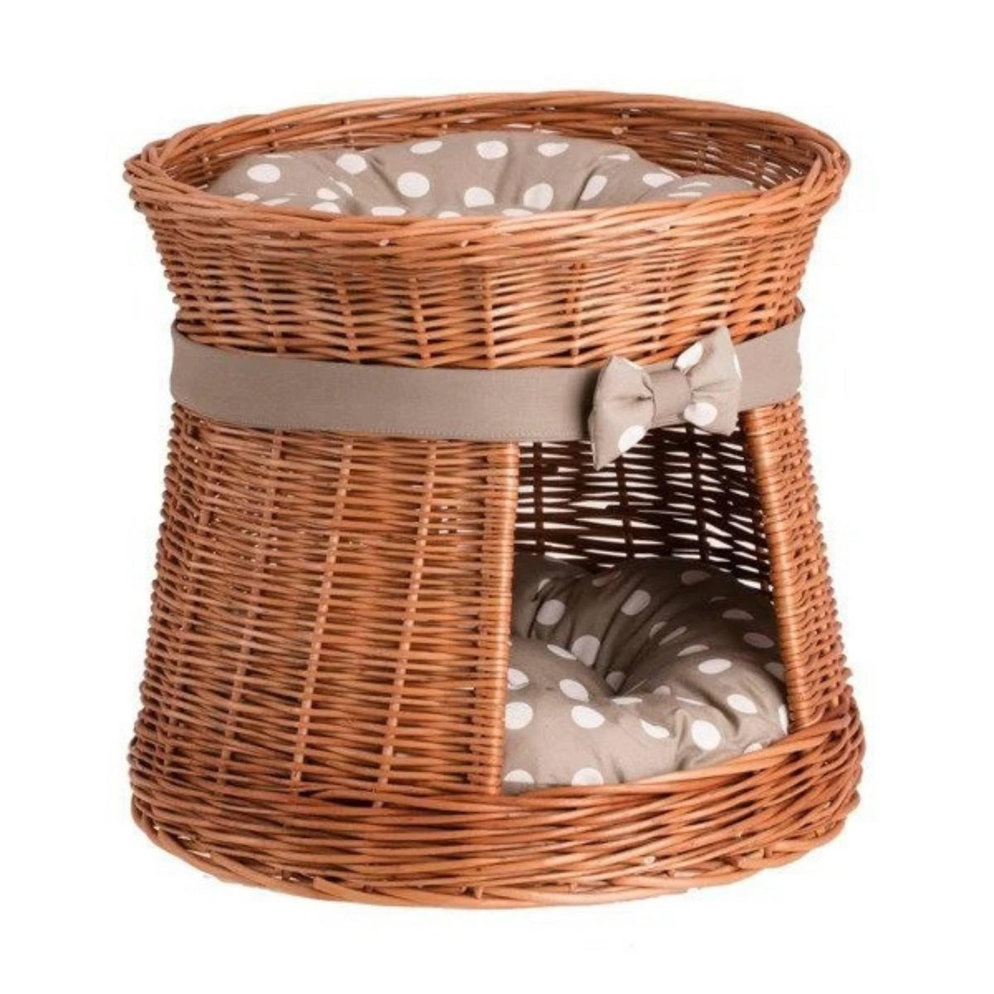 Wicker pet bed with polka dot cushion on a white background