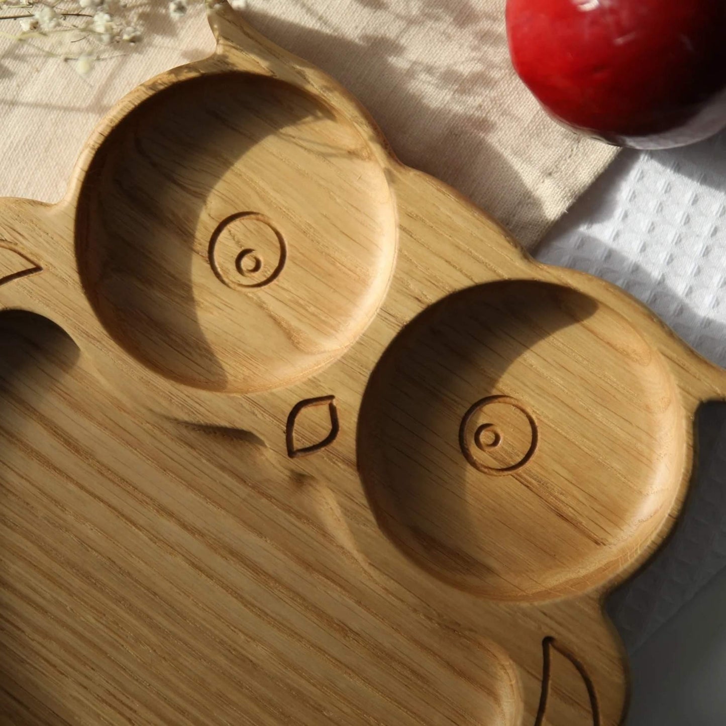 Wooden tray with circular indentations on a textured surface