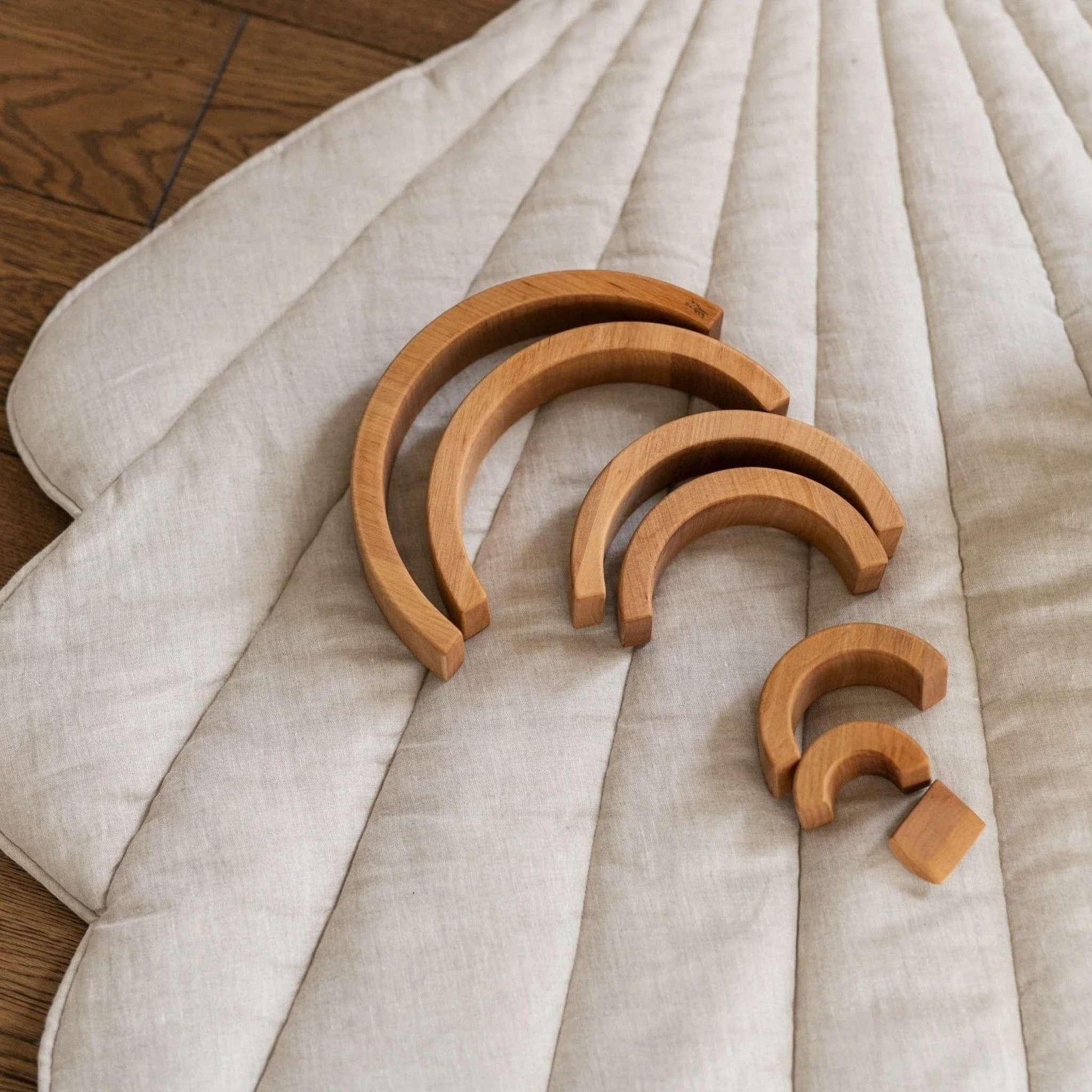 Set of wooden arcs on a textured fabric surface