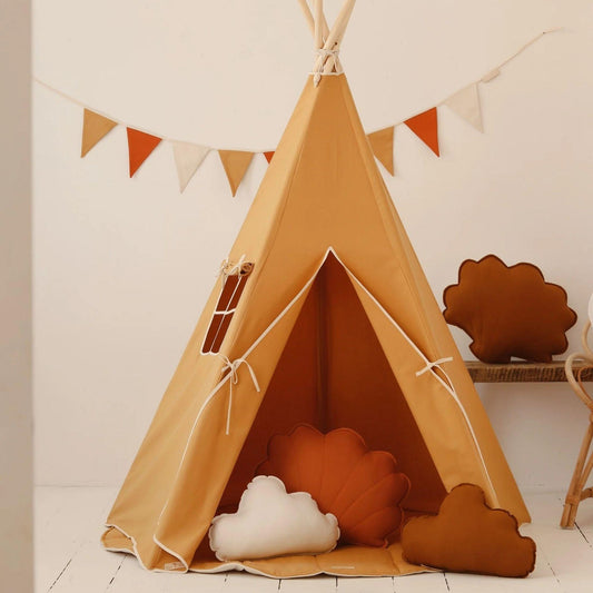 Children's teepee with decorative pillows and a banner in a room setting