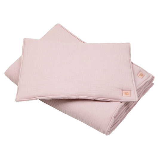 Folded pink blanket with a brand logo on a white background