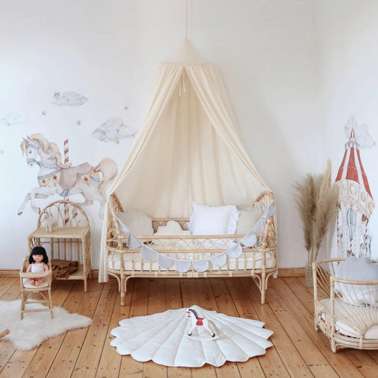 Children's room with a crib, rocking horse, and toys on a wooden floor.