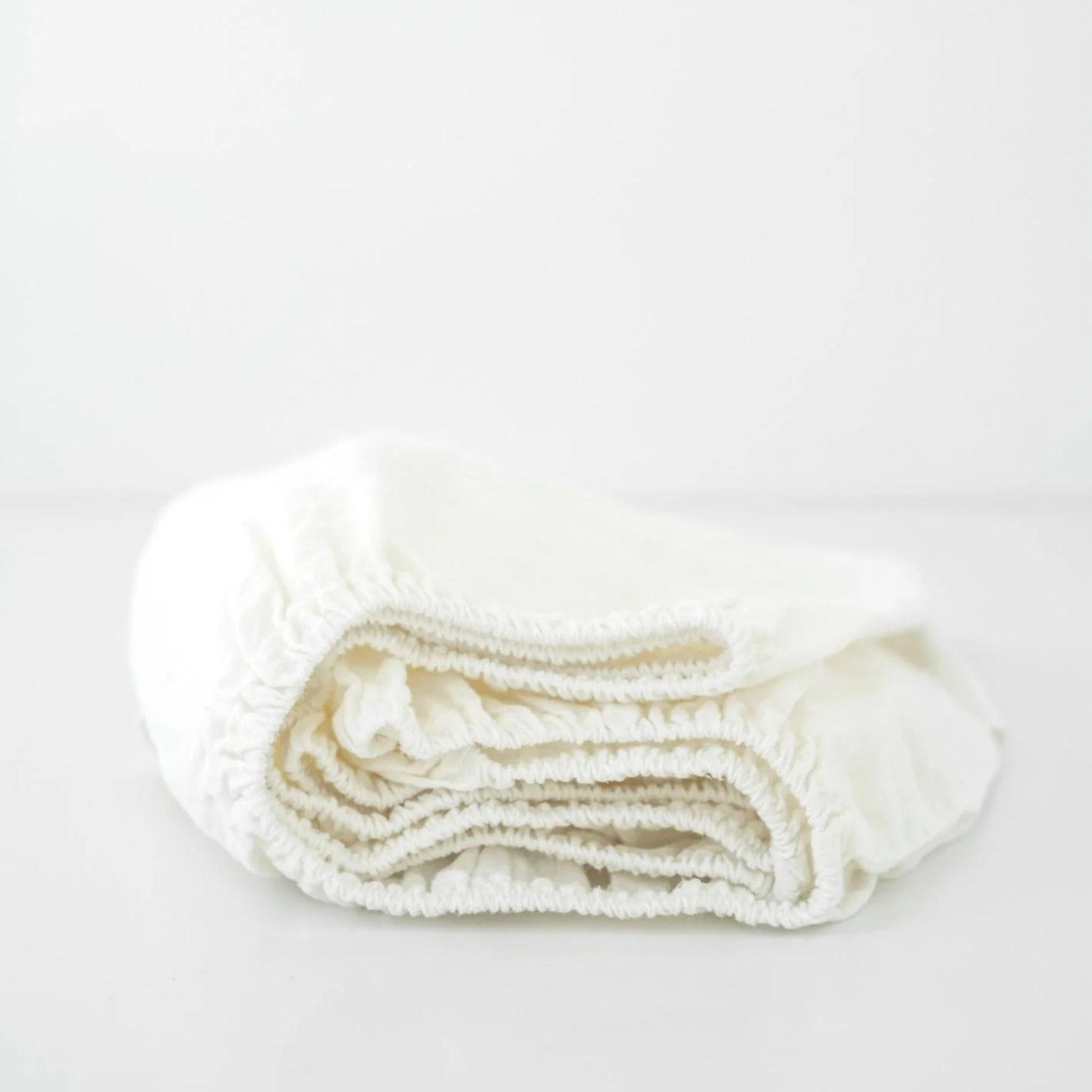 Folded white towel on a light gray background