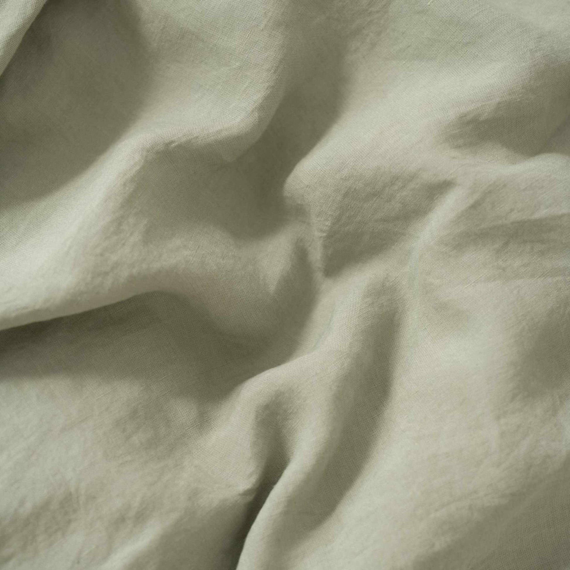 Close-up of light green fabric with folds