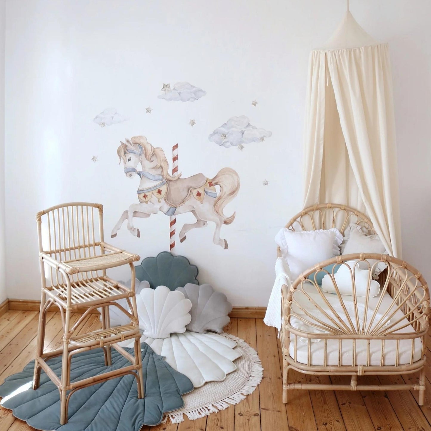 Children's room with wooden high chair, crib, and decorative wall art.