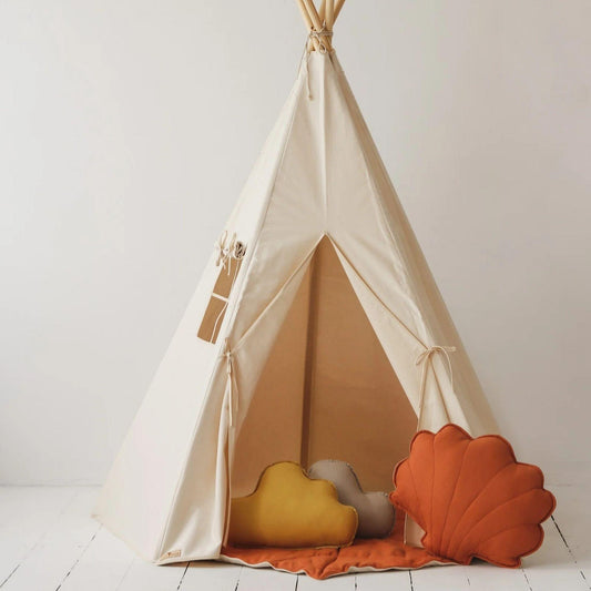 Children's teepee with colorful pillows on a white floor and wall