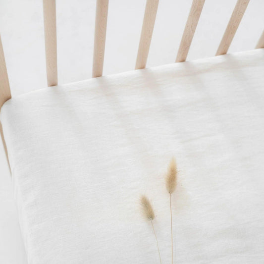 Close-up of a white cushion on a chair with a blurred background