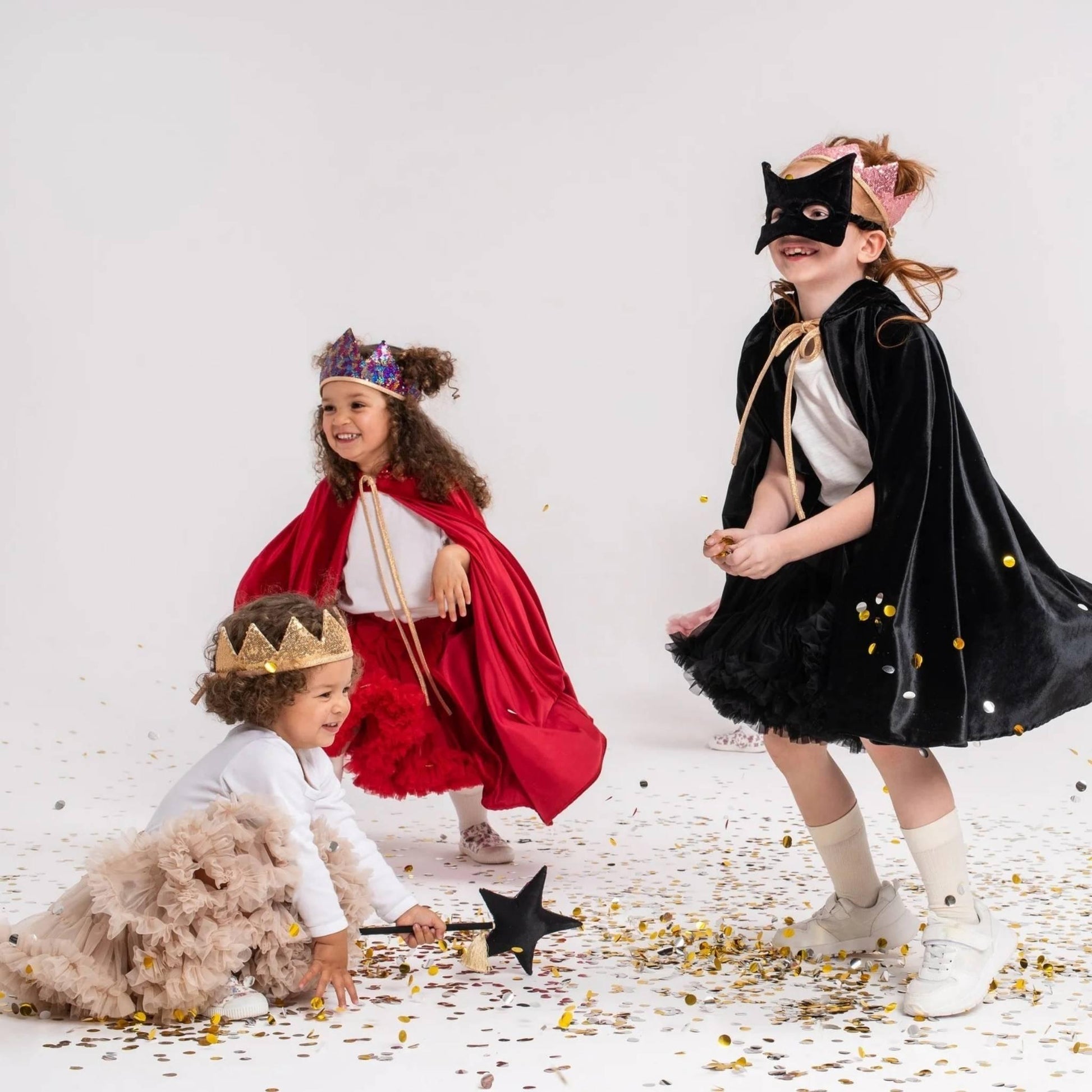Three children in costumes on a white background