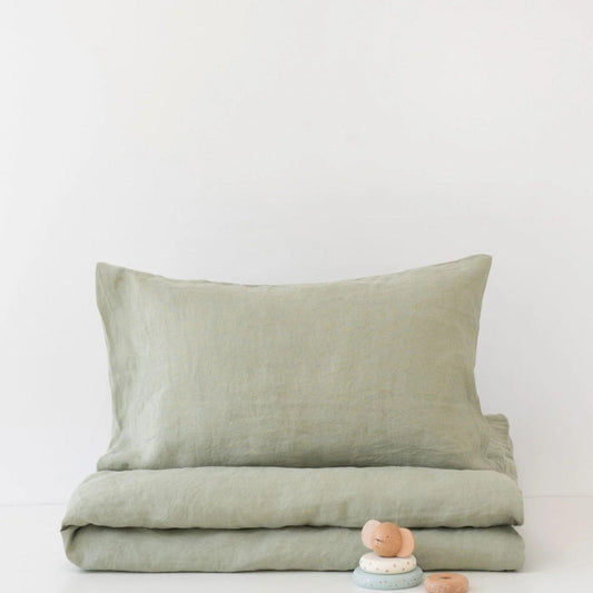 Green bedding set with a pillow on a white background