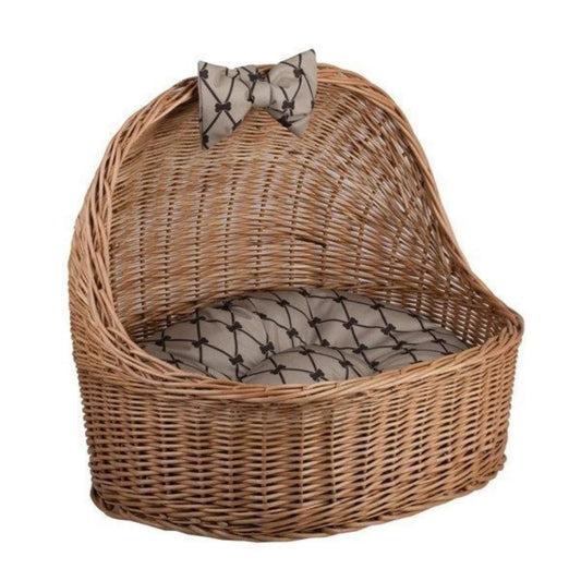 Wicker pet bed with a patterned cushion on a white background