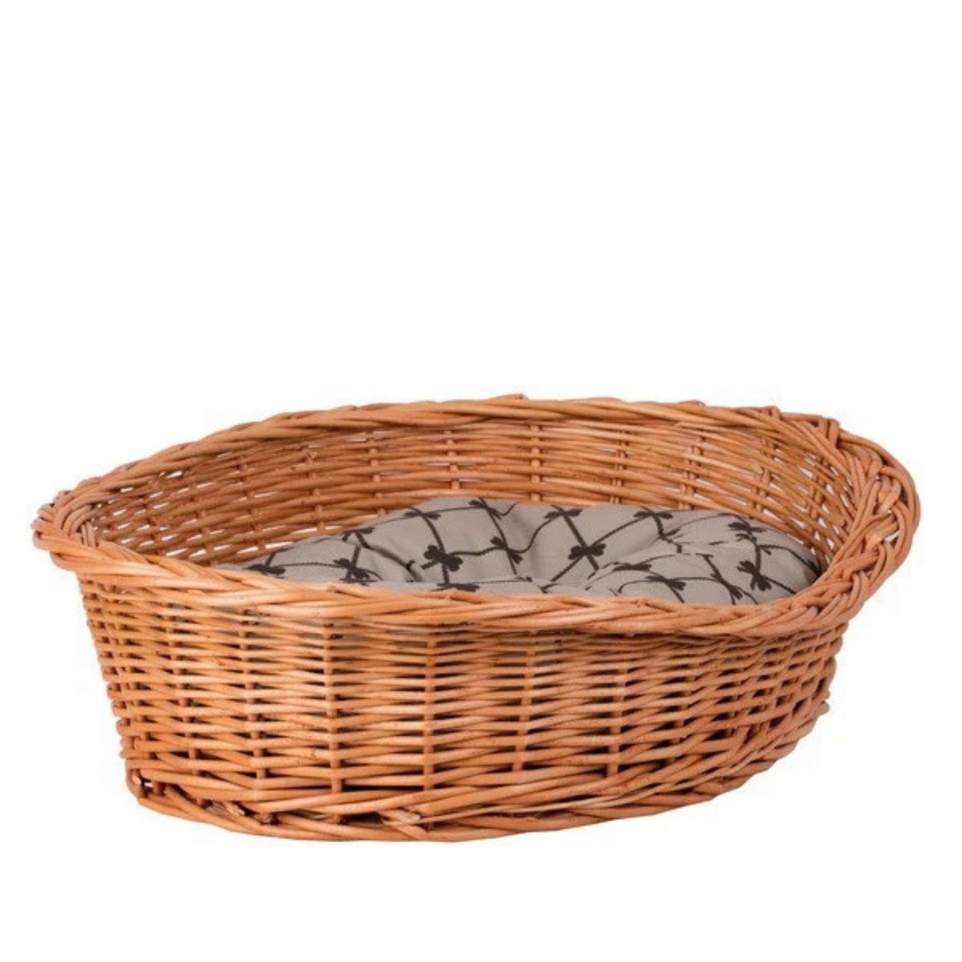 Wicker pet bed with a gray cushion on a white background