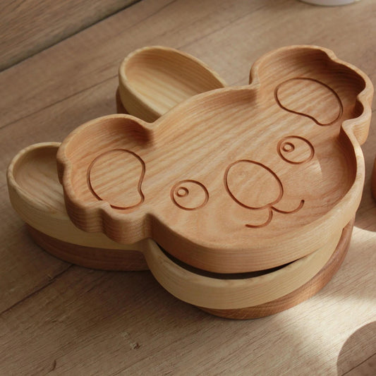 Wooden panda-shaped box on a wooden surface