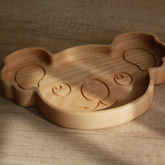 Wooden puzzle shaped like a bear on a wooden surface