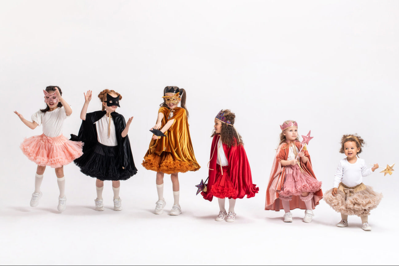Children in various halloween costumes on a white background