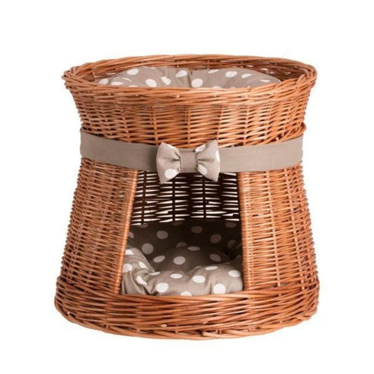 Wicker pet bed with a gray cushion and bow on a white background