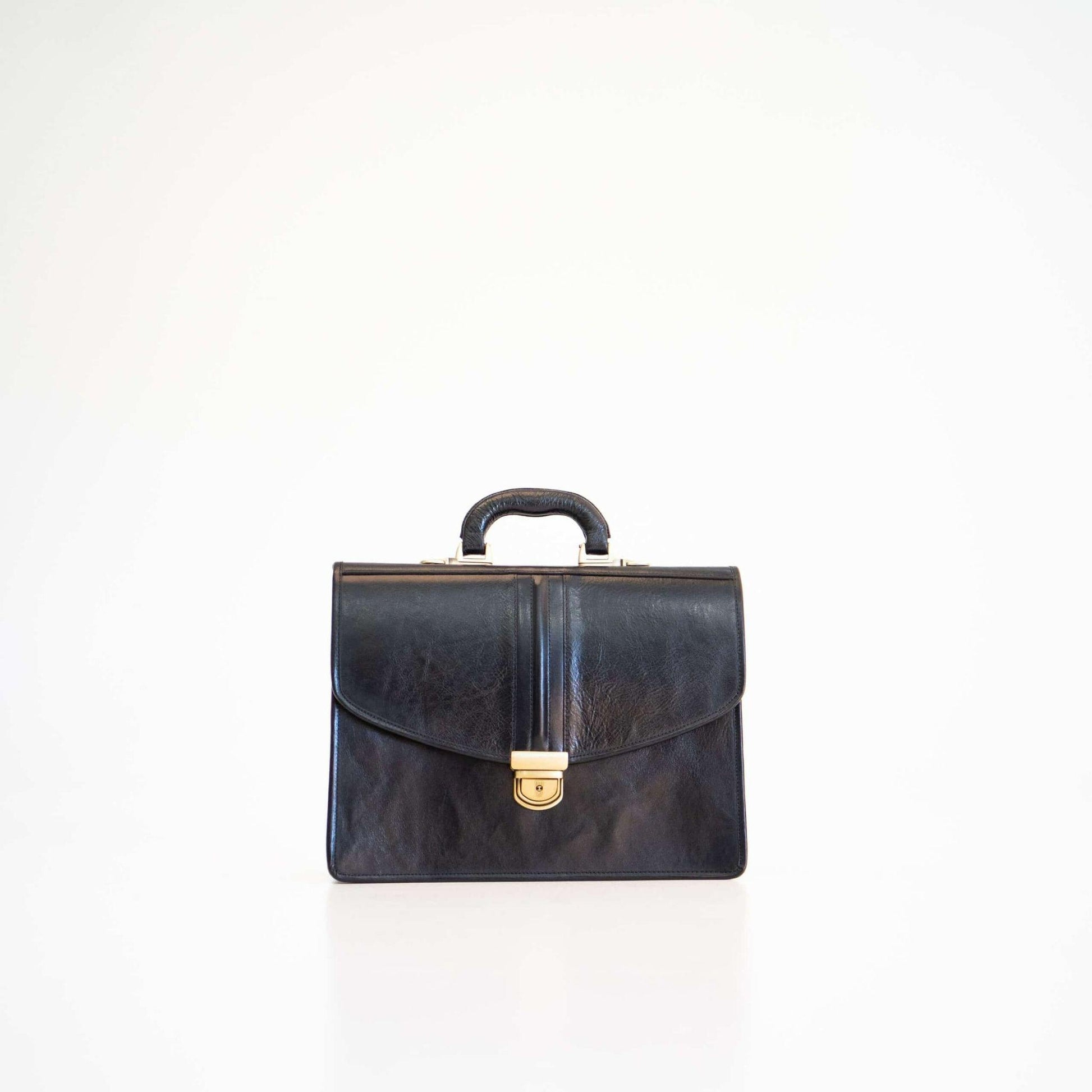Black leather briefcase with gold clasp on a white background