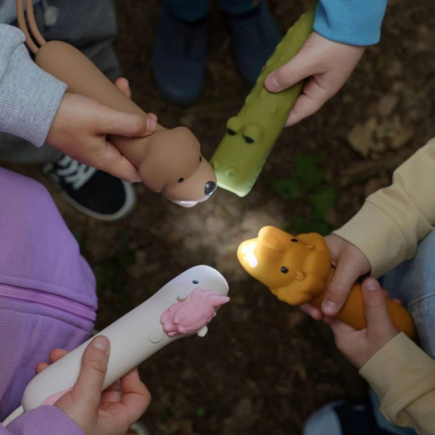 Children holding animal-shaped toys in a circle on a natural background