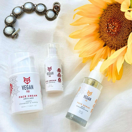 Vegan skincare products with a sunflower on a white background