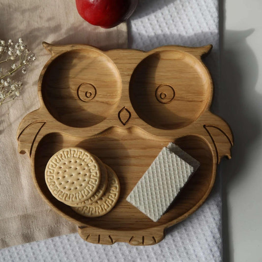Wooden owl-shaped tray with cookies on a light background